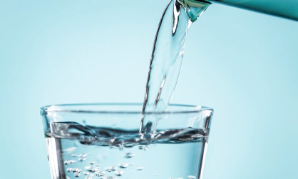 pouring water on a glass